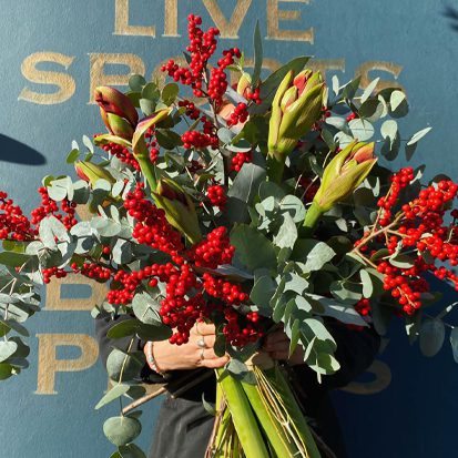 A large festive bouquet of reds and greens