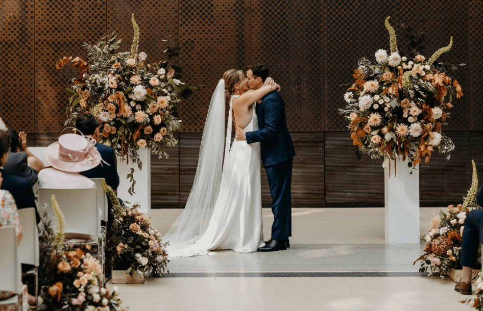 Wedding_flowers_London_3 A couple kiss surrounded by huge floral displays