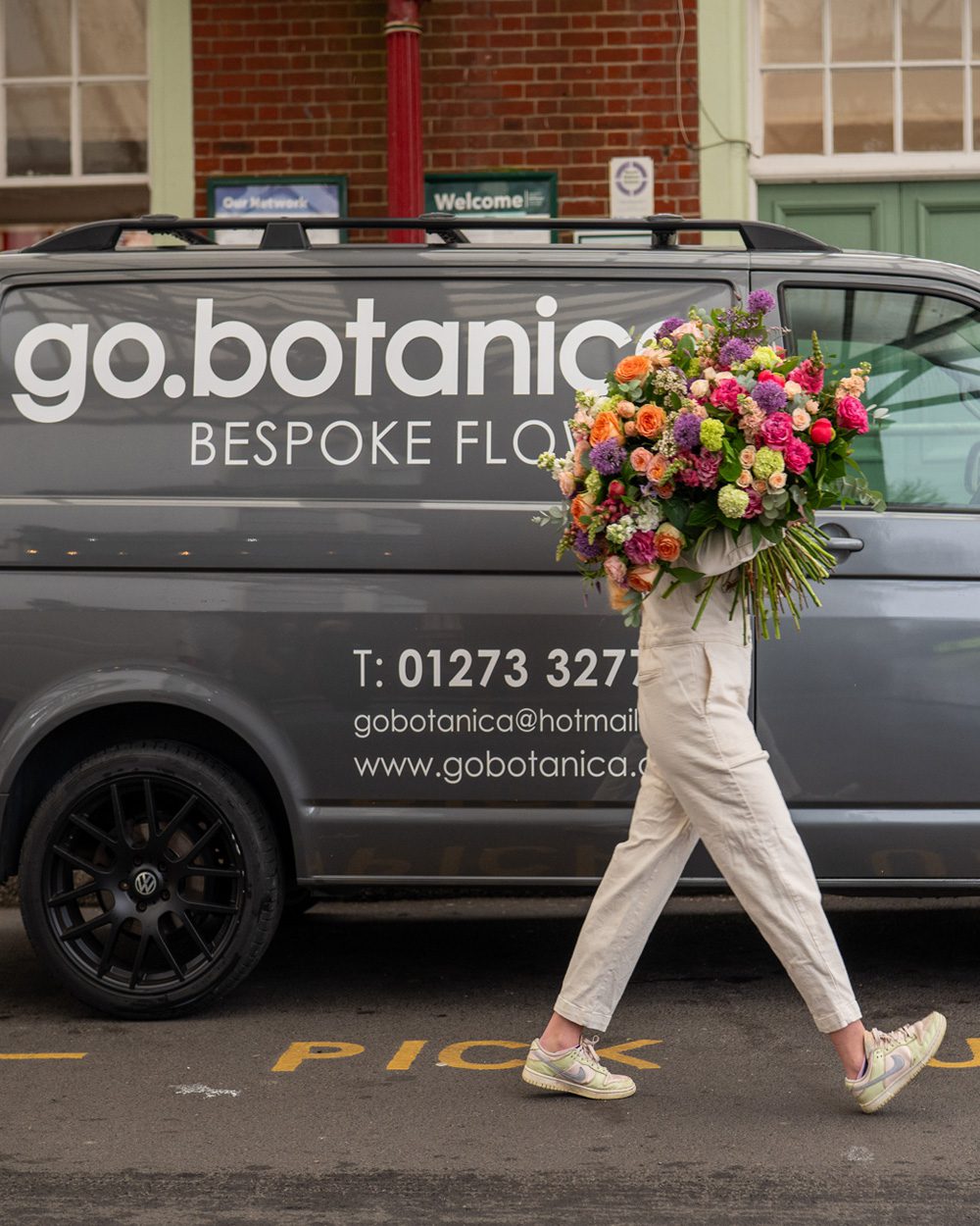 Woman walking with large bouquet of flowers