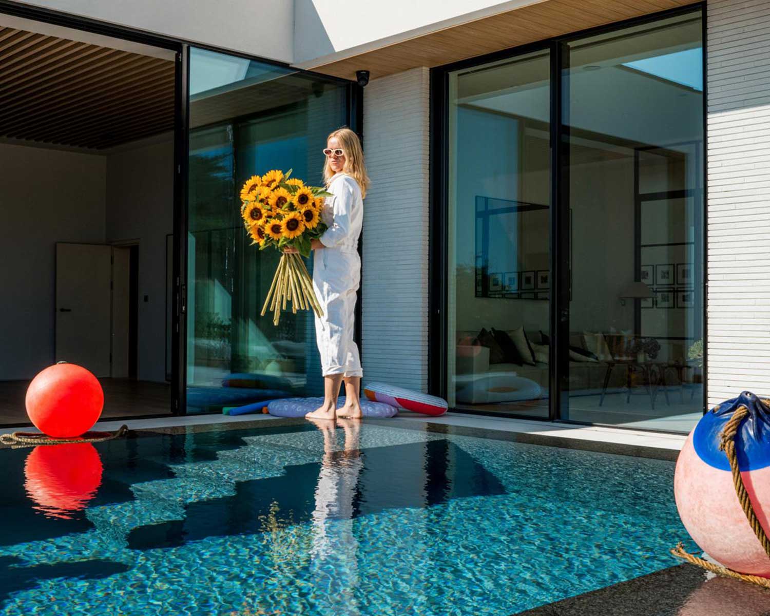 whats-hot-for-easter1 woman by a pool with floral outfit